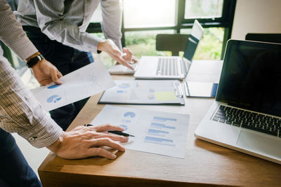 People working on table in office