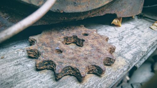 Close-up of rusty metal on wood