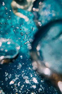 Close-up of water drops on blue surface