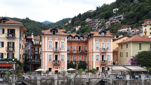 Houses by street in town against sky