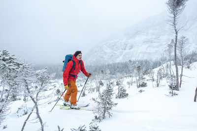 Man skiing through a boulder field in the alpine