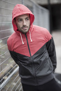 Sporty man in hooded jacket