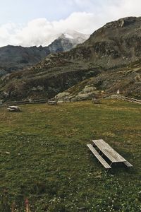 Scenic view of field and mountains against sky