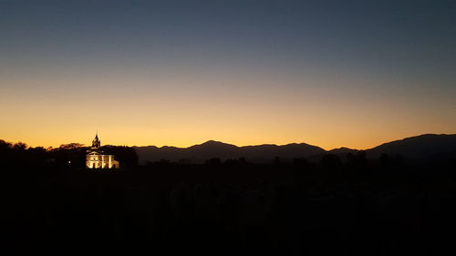 Silhouette of temple against clear sky