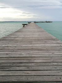 Pier on sea against sky