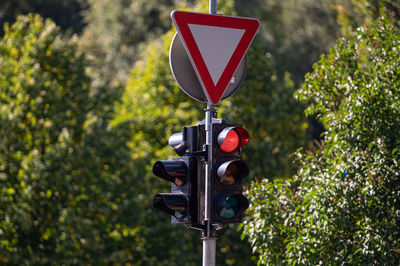 Close-up of road sign against trees