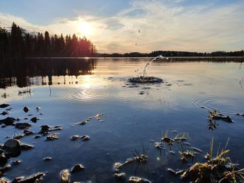 Scenic view of lake against sky during sunset