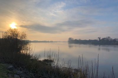 Scenic view of lake against sky during sunset