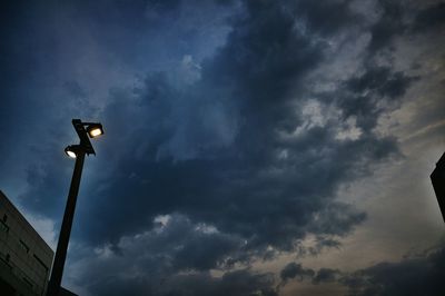 Low angle view of street light against cloudy sky