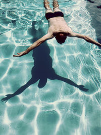 High angle view of woman swimming in pool