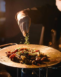 Cropped hand of person preparing food