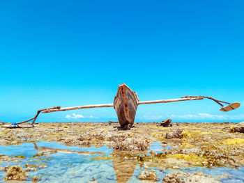 Close-up of rusty rope against blue sky