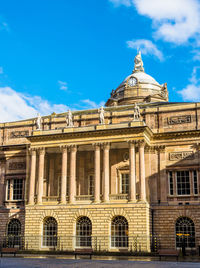 Low angle view of building against cloudy sky