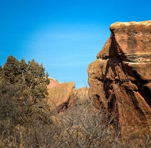 Low angle view of rock formation against clear blue sky