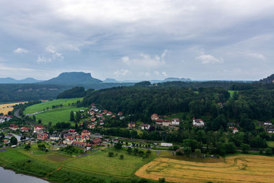 Scenic view of trees and buildings against sky