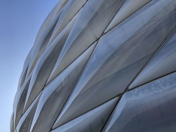 Low angle view of glass building against sky