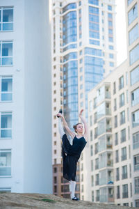 Full length of man standing against building in city