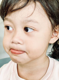 Close-up portrait of cute girl looking away