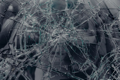 Close-up of broken glass window