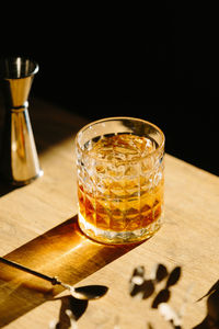 Close-up of glass with bourbon whiskey on table