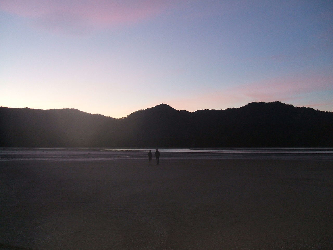 SILHOUETTE OF MAN ON MOUNTAIN AGAINST SKY