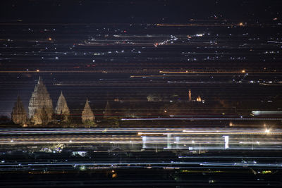 Aerial view of city lit up at night