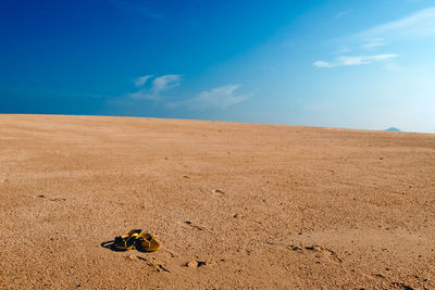 Scenic view of desert against blue sky