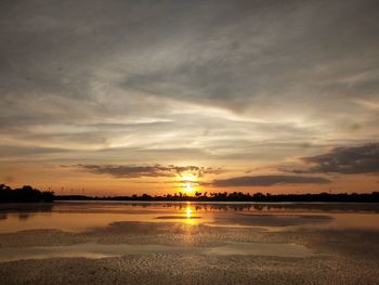 Scenic view of beach against sky during sunset