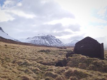 Scenic view of mountains against cloudy sky