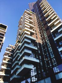 Low angle view of modern buildings against clear sky