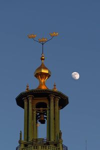 Low angle view of bell tower against blue sky