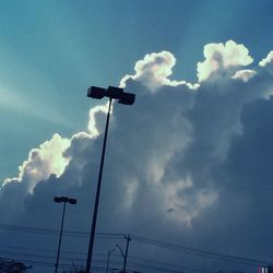 Low angle view of street light against cloudy sky