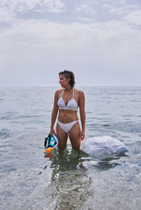 Full length of woman on beach against sky