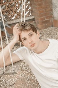 Portrait of young man on swing