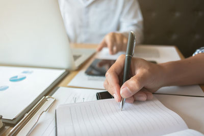 Midsection of woman working on table