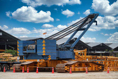 Cranes at construction site against sky