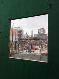 Cityscape against sky seen through window