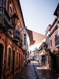 Narrow alley amidst buildings against sky