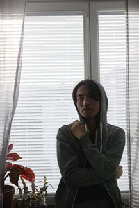 Man standing in front of window