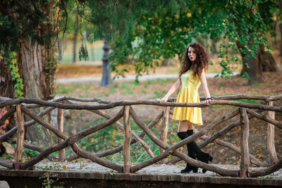 Woman standing against trees