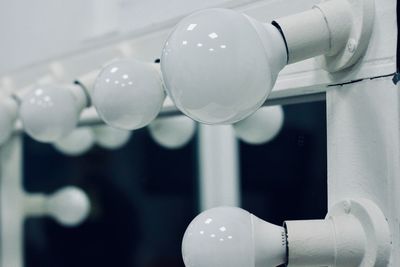 Low angle view of light bulbs hanging from ceiling