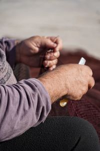 Close-up of man holding cigarette