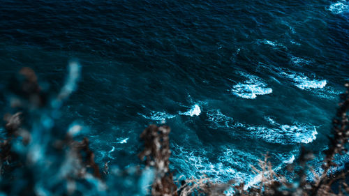 High angle view of rocks in sea