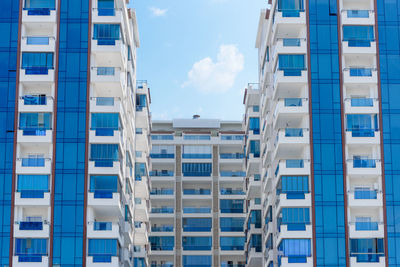 Abstract view of a multi-family residential complex of condominiums with window balconies painted 