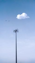 Low angle view of floodlight against blue sky