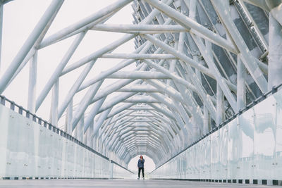 People walking on bridge against sky