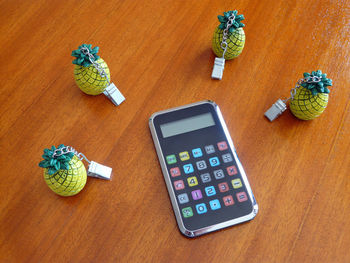 High angle view of mobile phone on wood