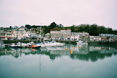 Boats in river with buildings in background