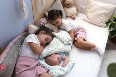 High angle view of baby boy sleeping on bed at home