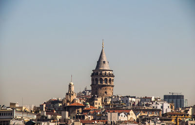 Church in town against clear sky